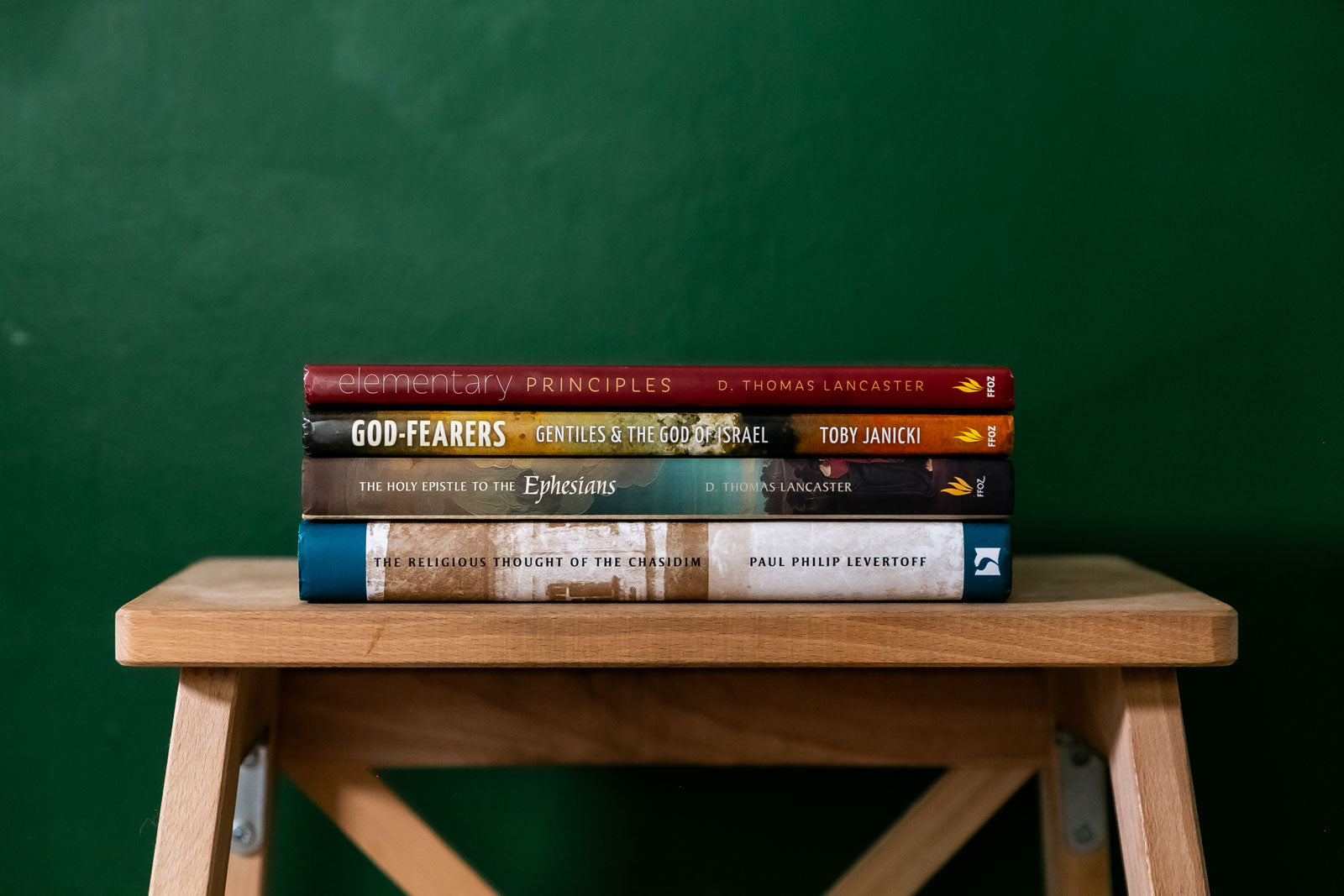 A neat stack of books published by First Fruits of Zion.